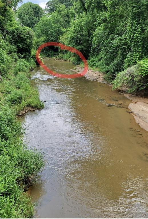 7 West Rambling Creek Drive Tryon, NC 28782 - Photo 3 of 15 a view of a lake with a yard