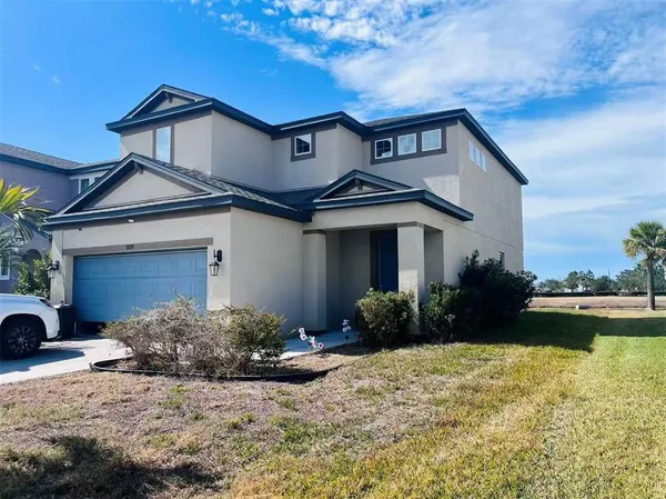 a front view of a house with a yard