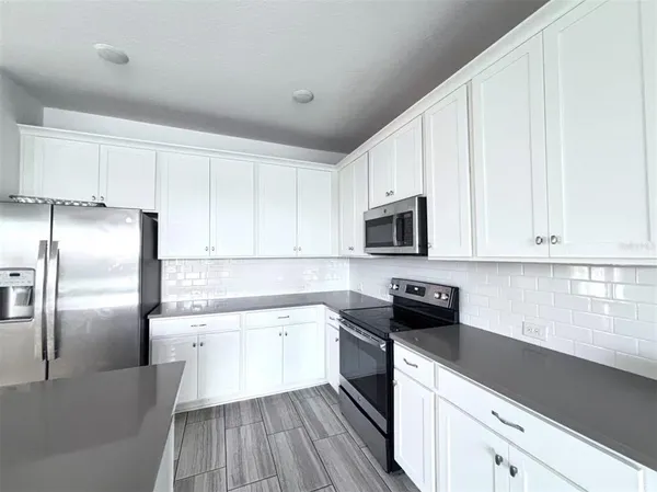 a kitchen with a sink stainless steel appliances and cabinets