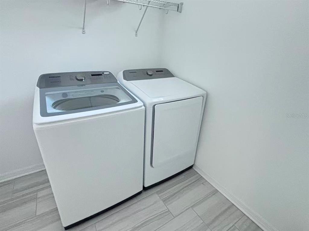 8569 Starlight Loop Parrish, FL 34219 - Photo 7 of 8 a utility room with dryer and washer