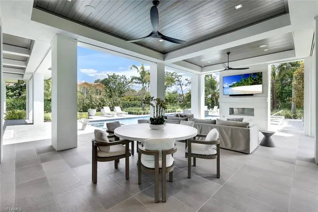 a dining room with furniture a chandelier and a rug