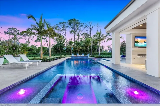 a view of swimming pool with outdoor seating
