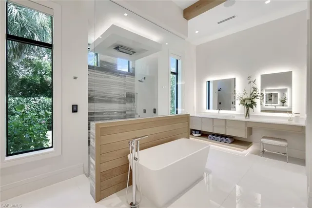 a bathroom with a bathtub sink and mirror