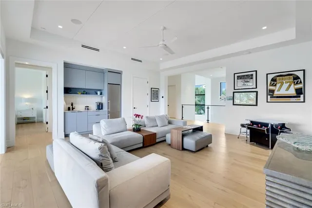 a living room with furniture and large windows