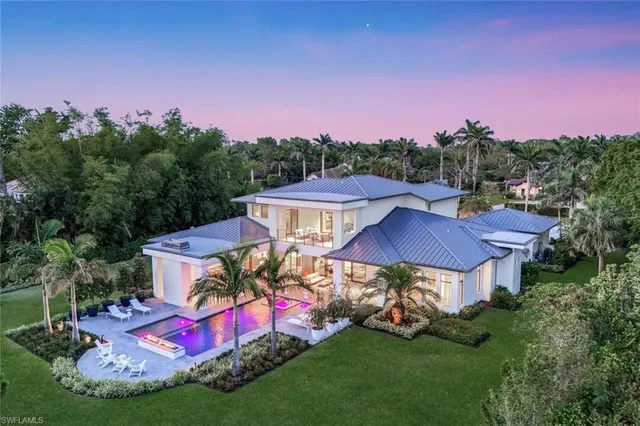 a view of a house with backyard sitting area and garden