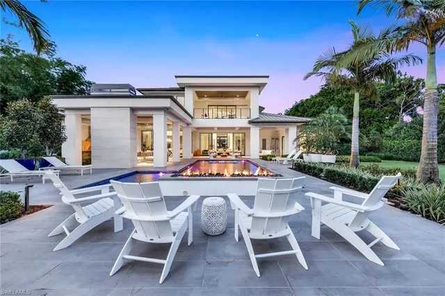 an aerial view of residential houses with outdoor space and trees