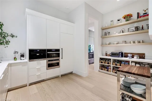 a kitchen with stainless steel appliances a cabinets and wooden floor