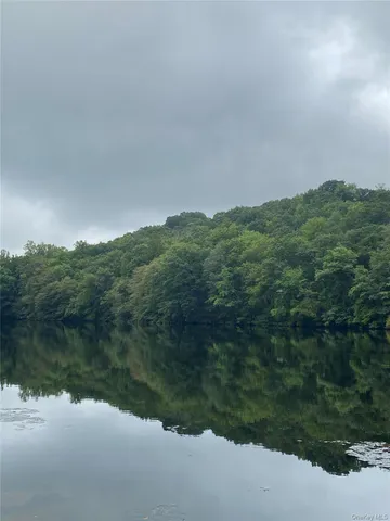 a view of a lake and green valley