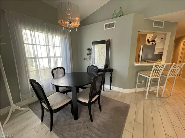 a dining room with furniture and window
