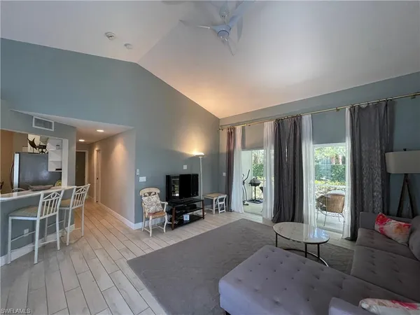 a living room with furniture a large window with wooden floor