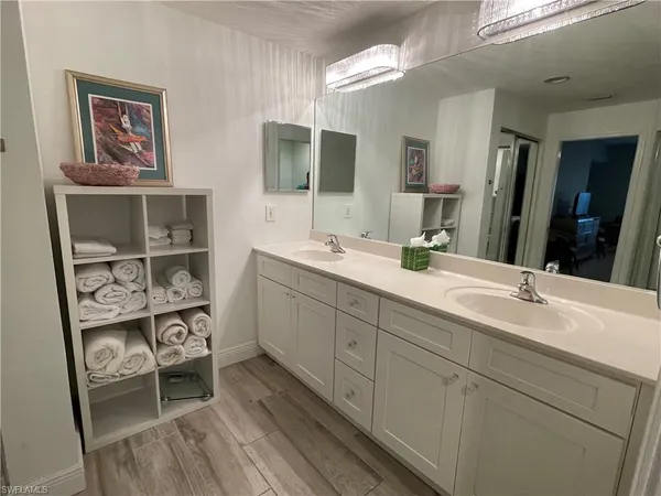 a bathroom with a double vanity sink and a mirror