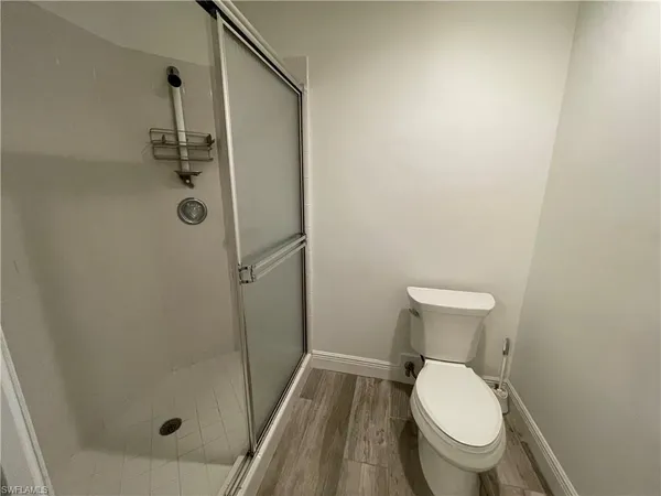 a bathroom with a toilet and a shower