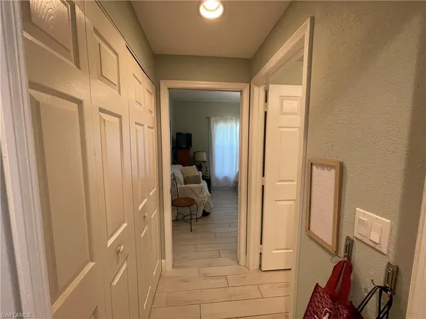a view of a hallway with furniture and a livingroom view