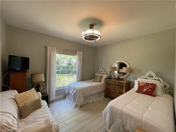 a bedroom with two beds and a window