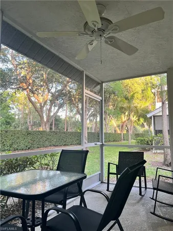 a view of a porch with furniture and a yard