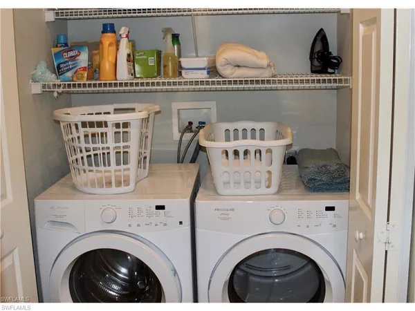a view of washer and dryer with kitchen countertop