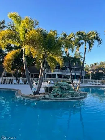 a view of a swimming pool with a table and chairs