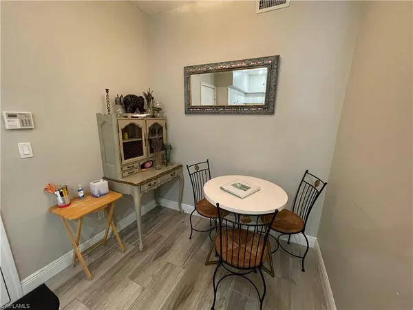 a view of a room with furniture and wooden floor