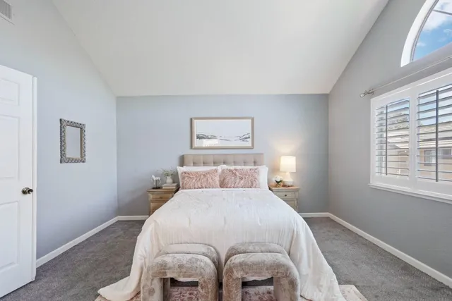 a bed room with a bed and a lamp