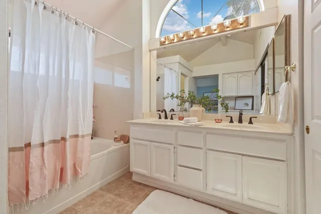 a bathroom with a double vanity sink and mirror