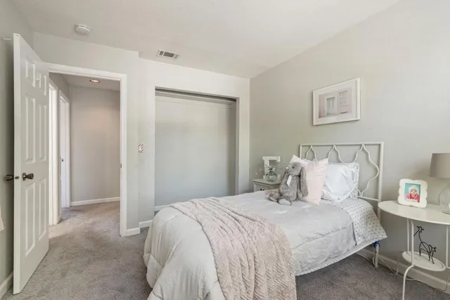 a bedroom with a bed and a night stand