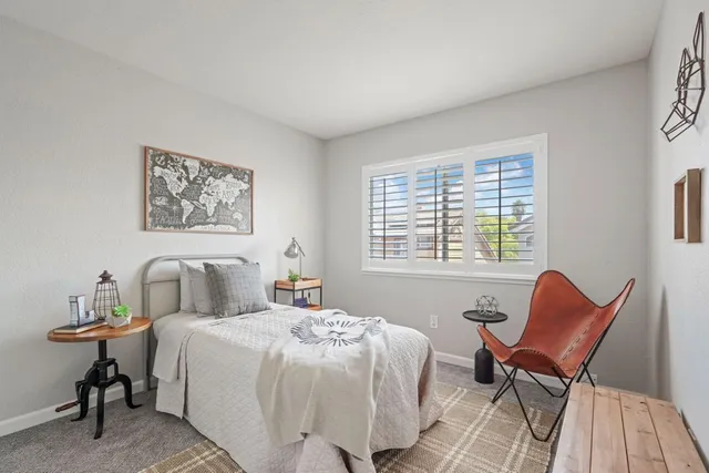 a bedroom with a bed and a chair