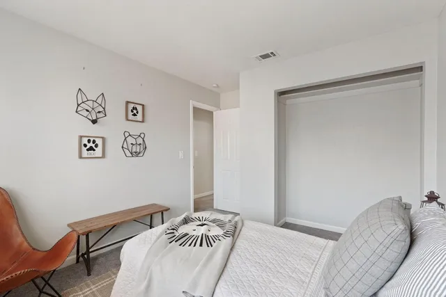 a bedroom with a bed and a chair