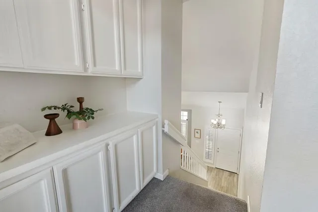 a hallway with white cabinets