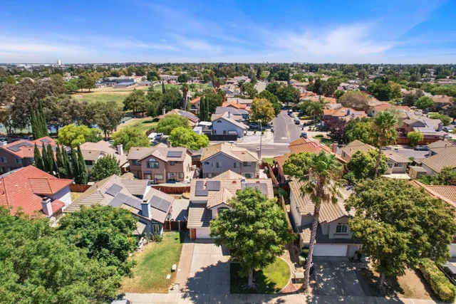 an aerial view of residential houses with outdoor space and river view