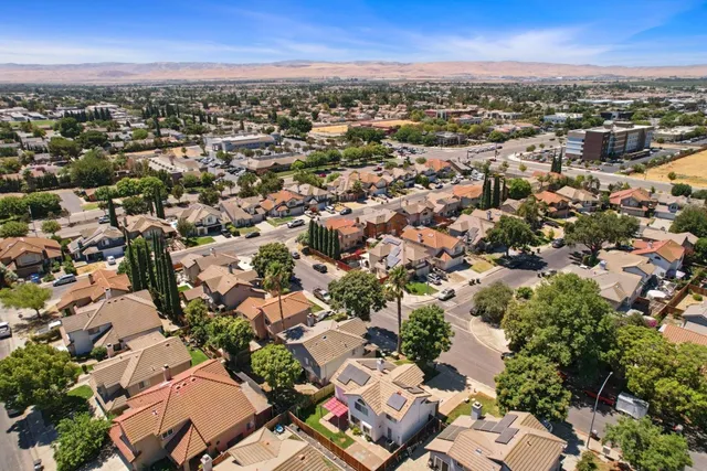 an aerial view of residential building with green space
