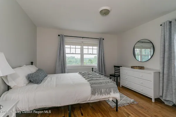 a bedroom with a large bed and a mirror