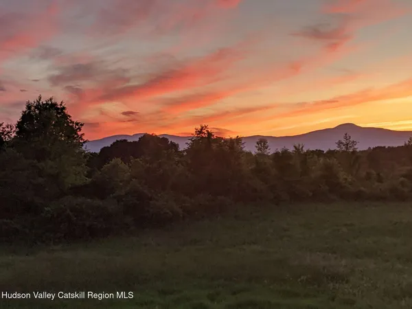 a view of mountain with sunset view