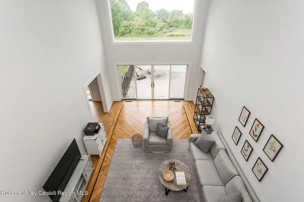 a living room with furniture and a floor to ceiling window