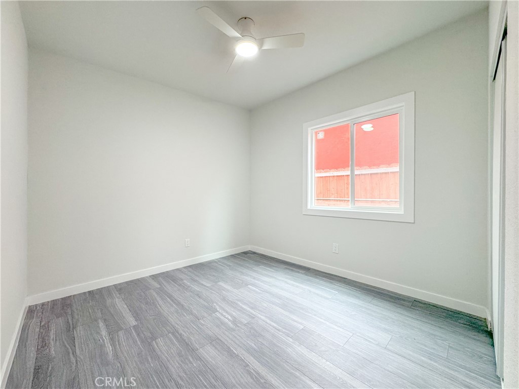 1366 West 152nd Street Compton, CA 90220 - Photo 16 of 30 an empty room with wooden floor and windows