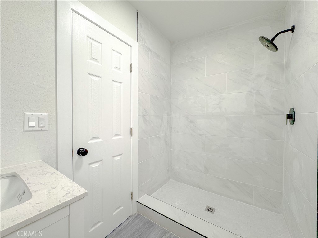 1366 West 152nd Street Compton, CA 90220 - Photo 18 of 30 a bathroom with a granite countertop sink a shower and a mirror