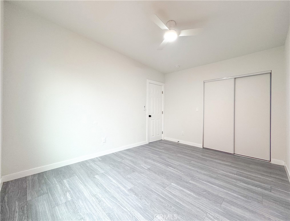 1366 West 152nd Street Compton, CA 90220 - Photo 20 of 30 a view of an empty room with wooden floor