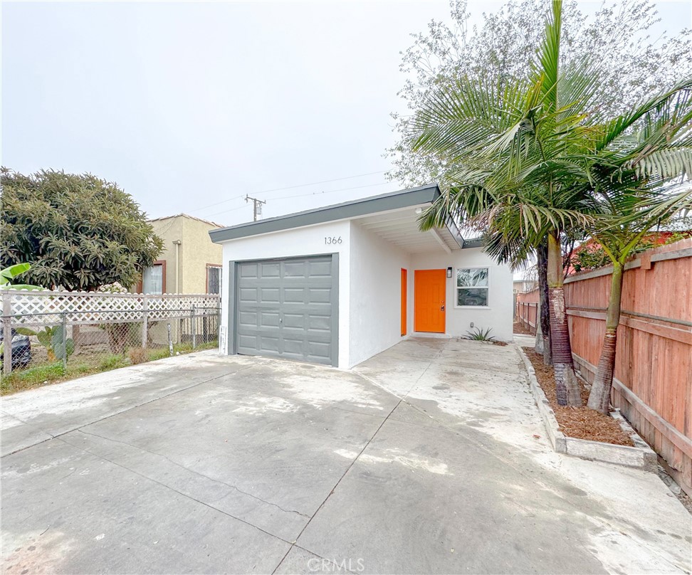 1366 West 152nd Street Compton, CA 90220 - Photo 2 of 30 a view of a house with a yard and garage