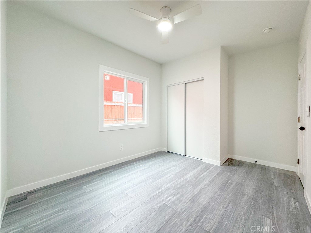1366 West 152nd Street Compton, CA 90220 - Photo 22 of 30 an empty room with wooden floor and windows