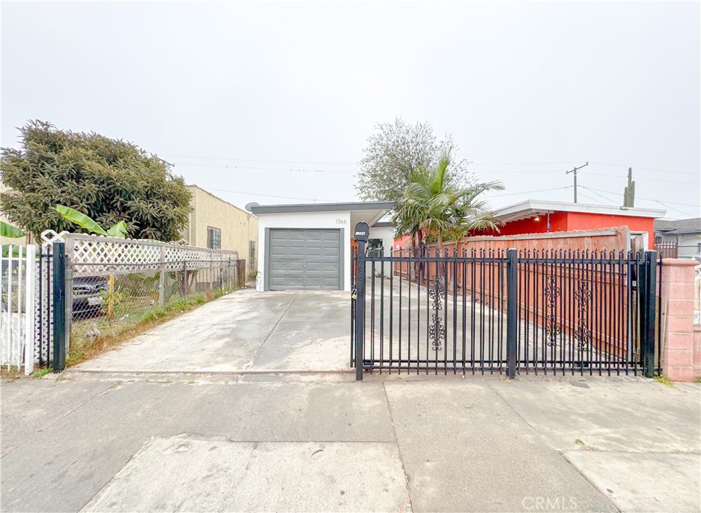 1366 West 152nd Street Compton, CA 90220 - Photo 3 of 30 a view of a entrance gate of the house and tree