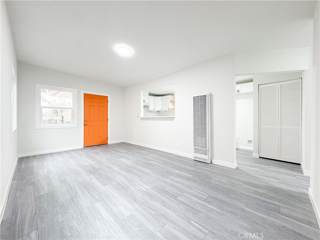 1366 West 152nd Street Compton, CA 90220 - Photo 8 of 30 an empty room with wooden floor and windows