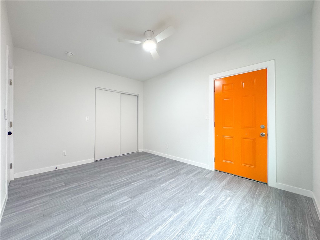 1366 West 152nd Street Compton, CA 90220 - Photo 9 of 30 a view of an empty room with wooden floor and a window