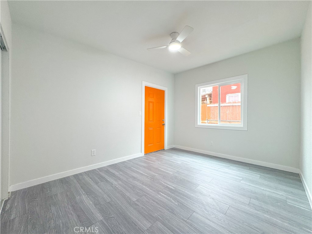 1366 West 152nd Street Compton, CA 90220 - Photo 10 of 30 an empty room with wooden floor and windows