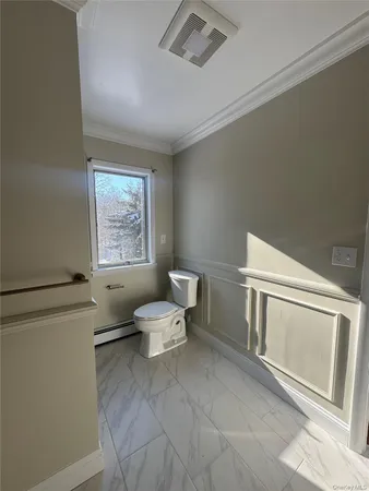 a white toilet sitting next to a bathroom sink