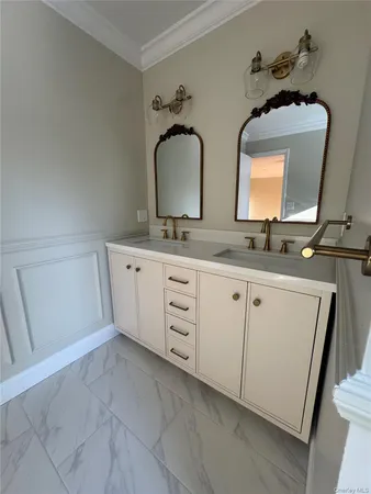 a bathroom with a double vanity sink and a mirror