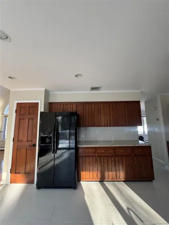 a kitchen with granite countertop a refrigerator and a stove