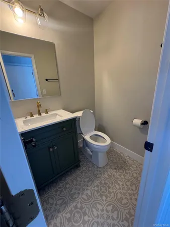 a spacious bathroom with a toilet sink and mirror
