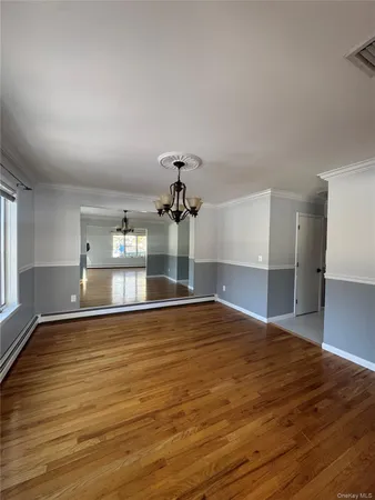 a view of a room with wooden floor