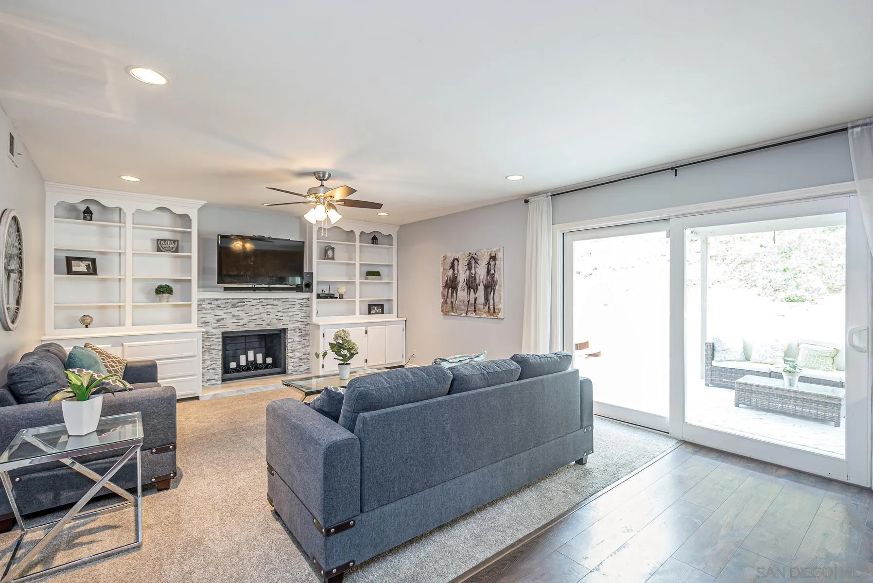 10046 Fieldcrest Street Spring Valley, CA 91977 - Photo 8 of 42 a living room with furniture a fireplace and a flat screen tv