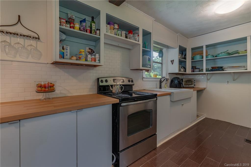 265 Carson Street Tryon, NC 28782 - Photo 11 of 28 a kitchen with stainless steel appliances granite countertop a stove and a sink