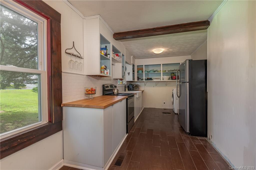 265 Carson Street Tryon, NC 28782 - Photo 13 of 28 a kitchen with stainless steel appliances granite countertop a refrigerator and a sink
